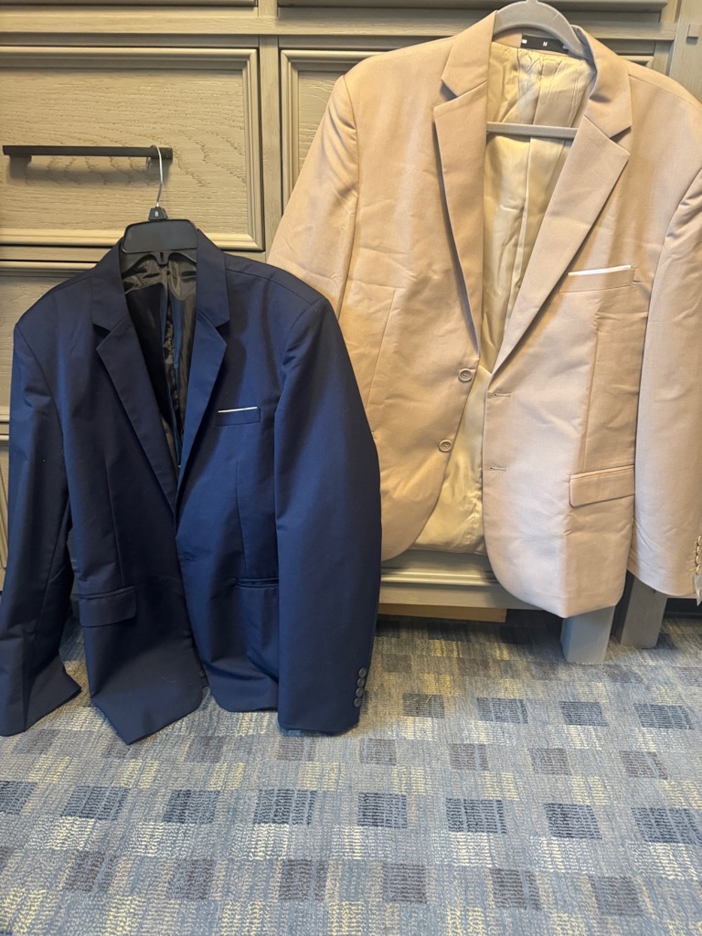 Two men’s size medium professional blazers. The tan was never worn. Blue worn 1x